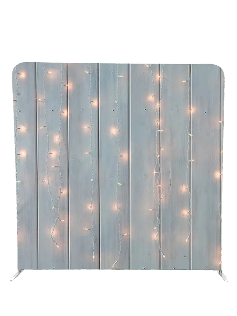 Rustic wooden photo booth backdrop with soft string lights by Crown Booths, perfect for cozy and romantic events